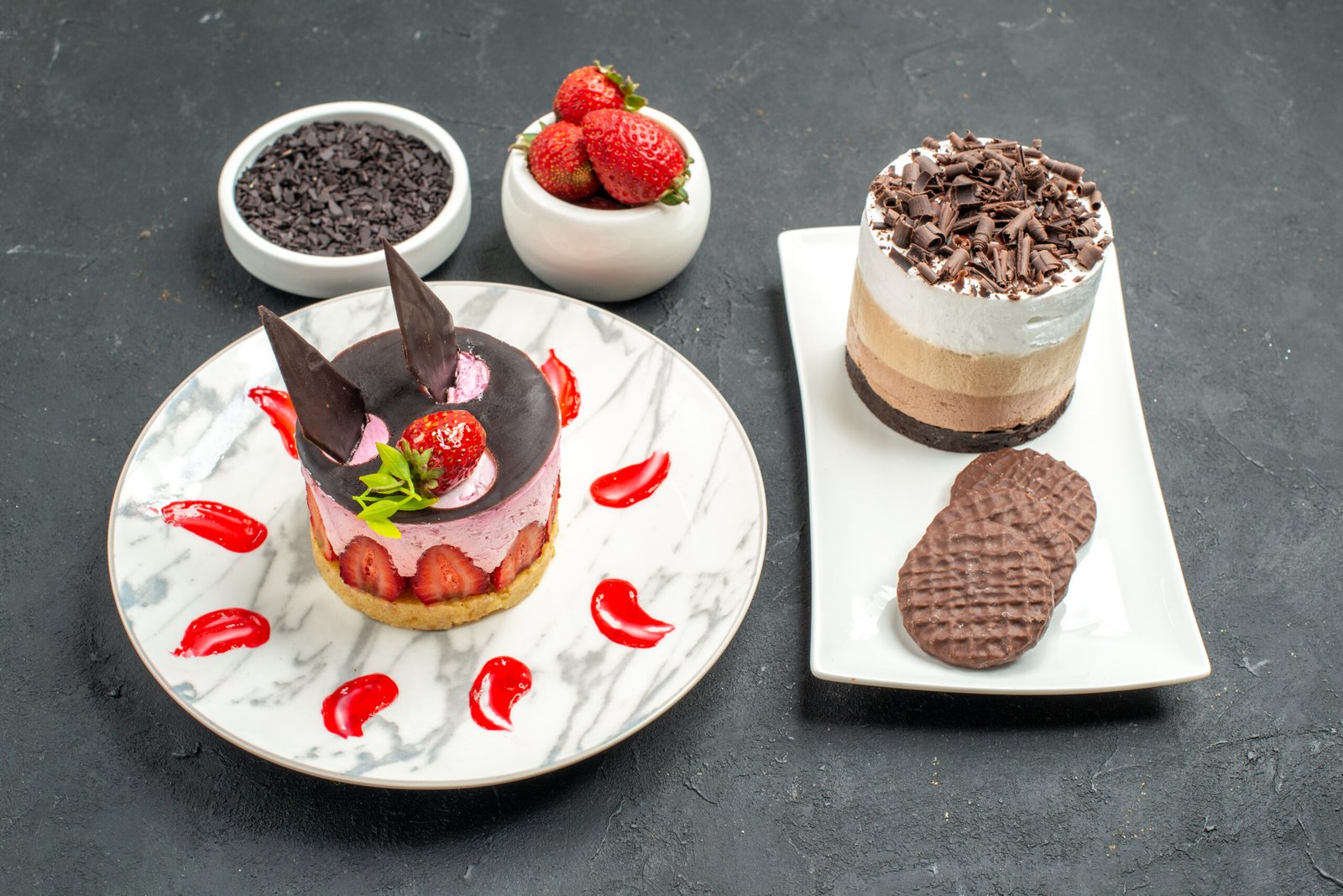 front-view-chocolate-cake-biscuits-white-rectangular-plate-strawberry-cheesecake-white